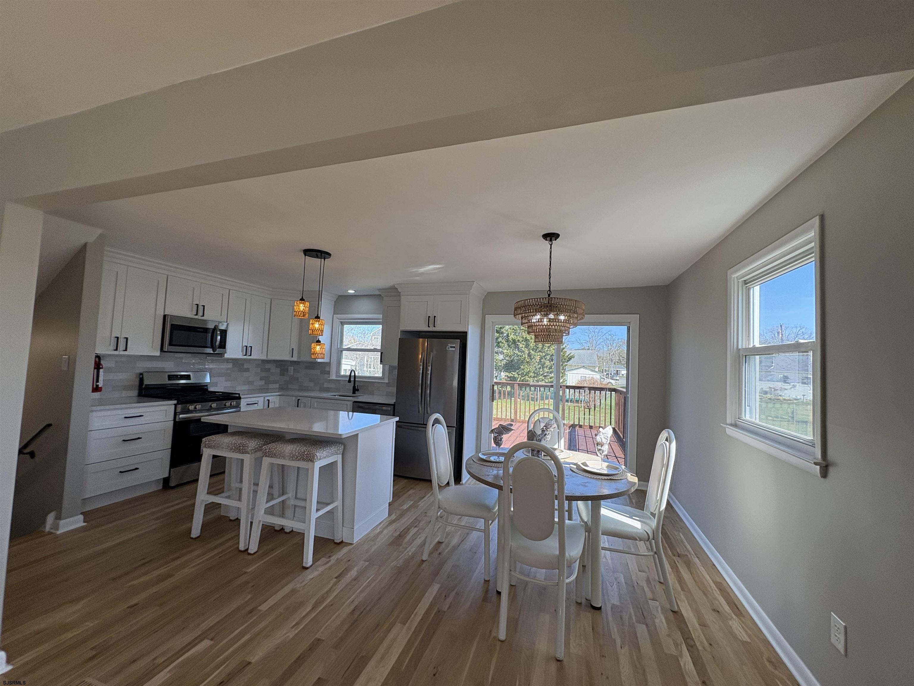 31 Gulph Mill Road Somers Point, NJ 08244 - Photo 7 of 32 a kitchen with a table chairs stove and cabinets