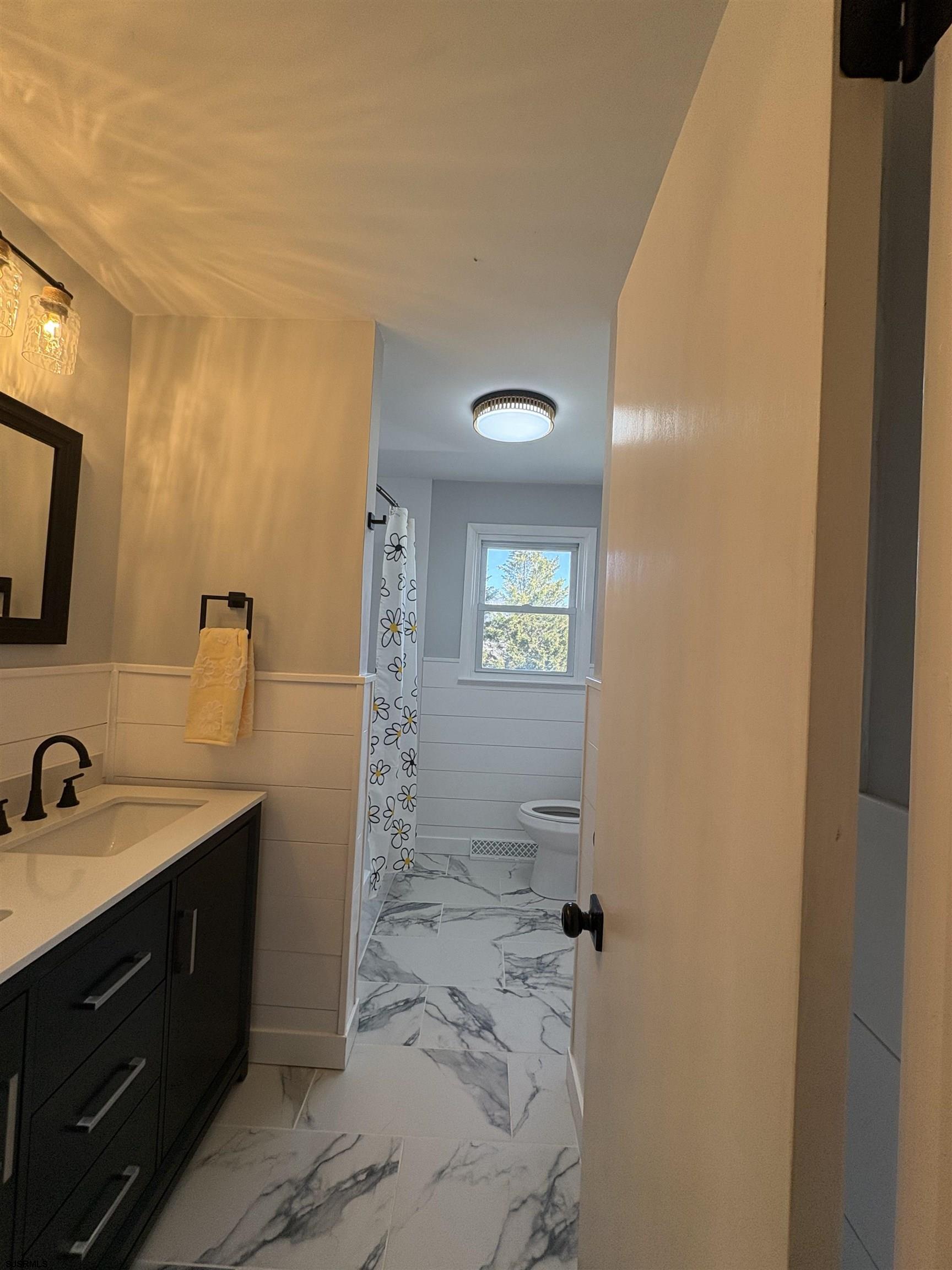 31 Gulph Mill Road Somers Point, NJ 08244 - Photo 9 of 32 a bathroom with a sink a toilet and shower