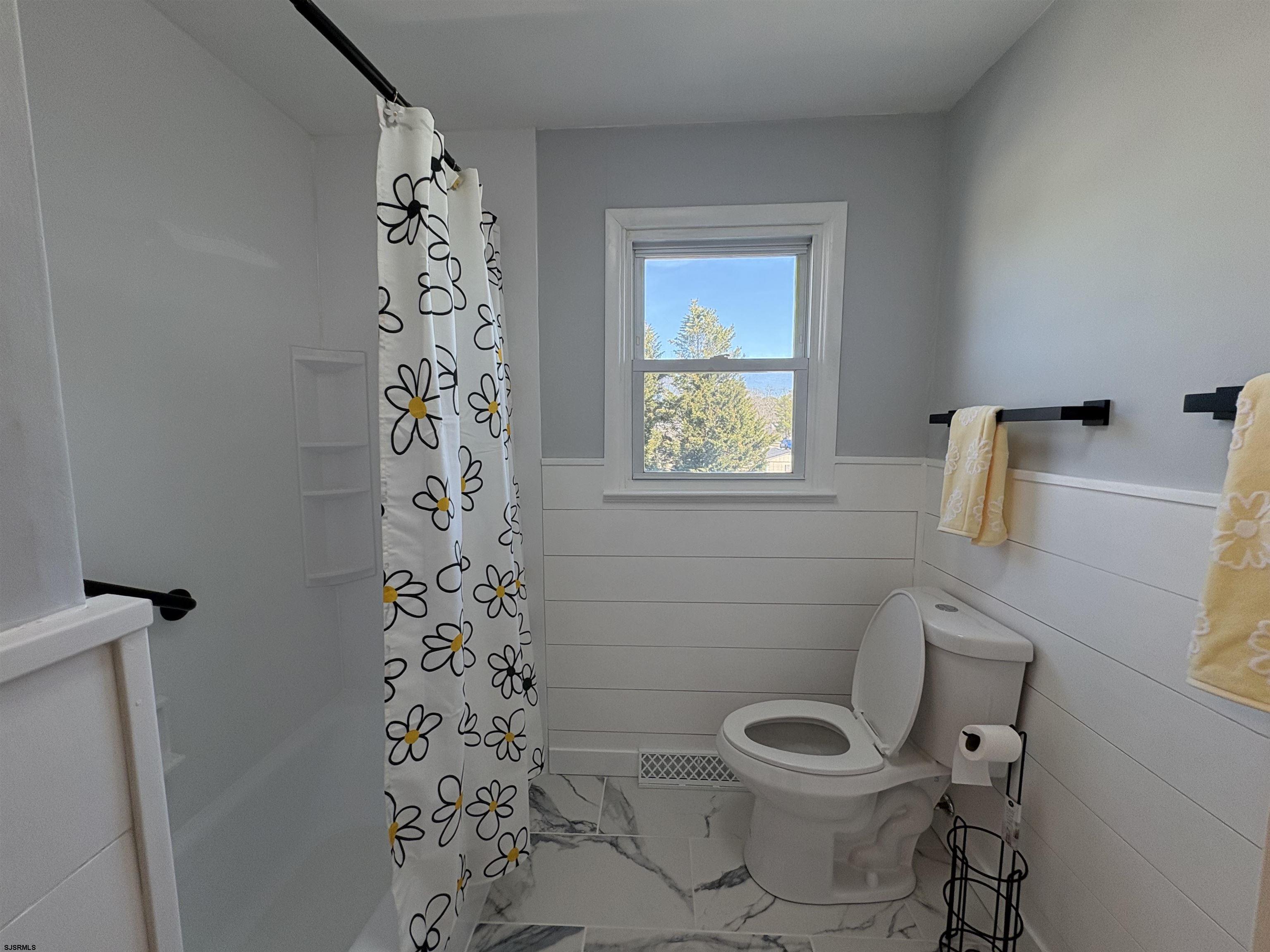 31 Gulph Mill Road Somers Point, NJ 08244 - Photo 10 of 32 a white toilet sitting next to a shower curtain