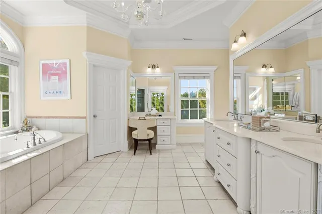 a spacious bathroom with a granite countertop sink mirror and bathtub