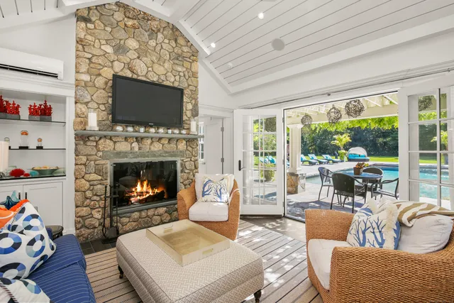 a living room with furniture a flat screen tv and a fireplace