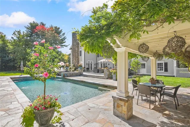 a view of a table and chairs in patio with a garden