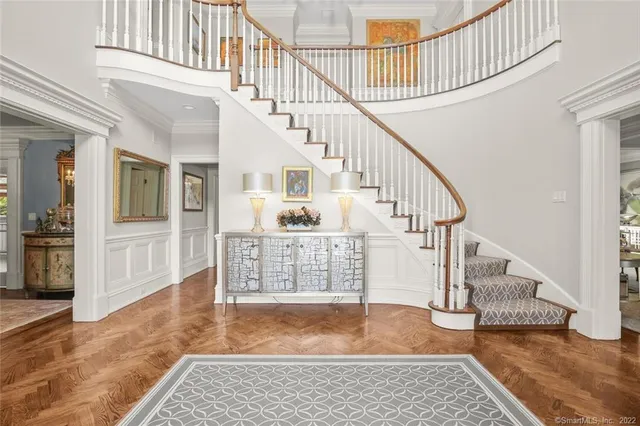 a view of entryway and hall with wooden floor