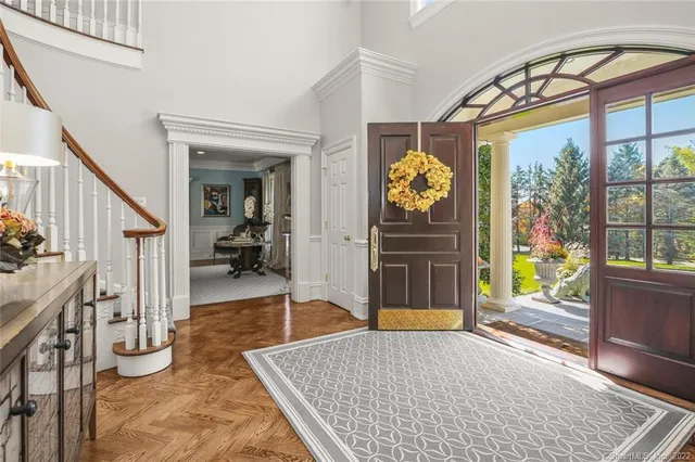a living room with furniture and a floor to ceiling window