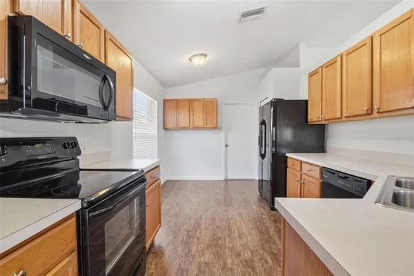 a kitchen with a stove and a microwave