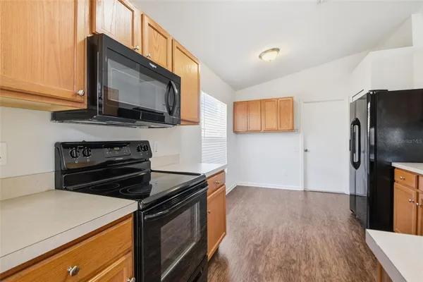 a kitchen with a refrigerator sink and stove