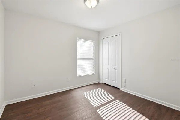 a view of an empty room and wooden floor
