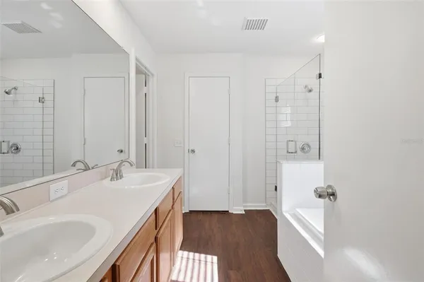 a bathroom with double vanity sinks and a mirror