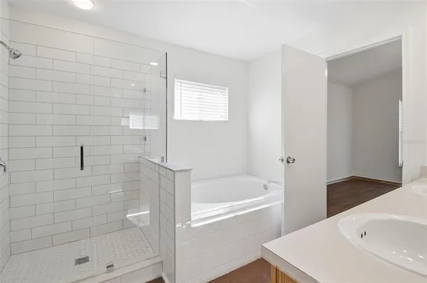 a bathroom with a sink toilet vanity and shower