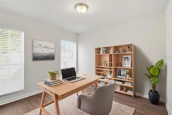 a view of a workspace with a bookshelf