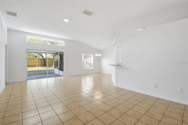 an empty room with windows and painted walls