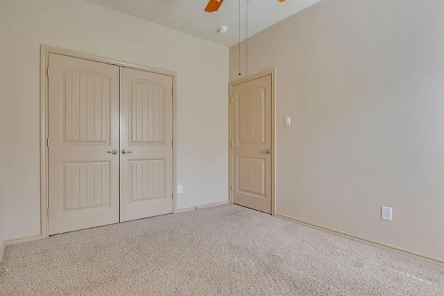 an empty room with closet area