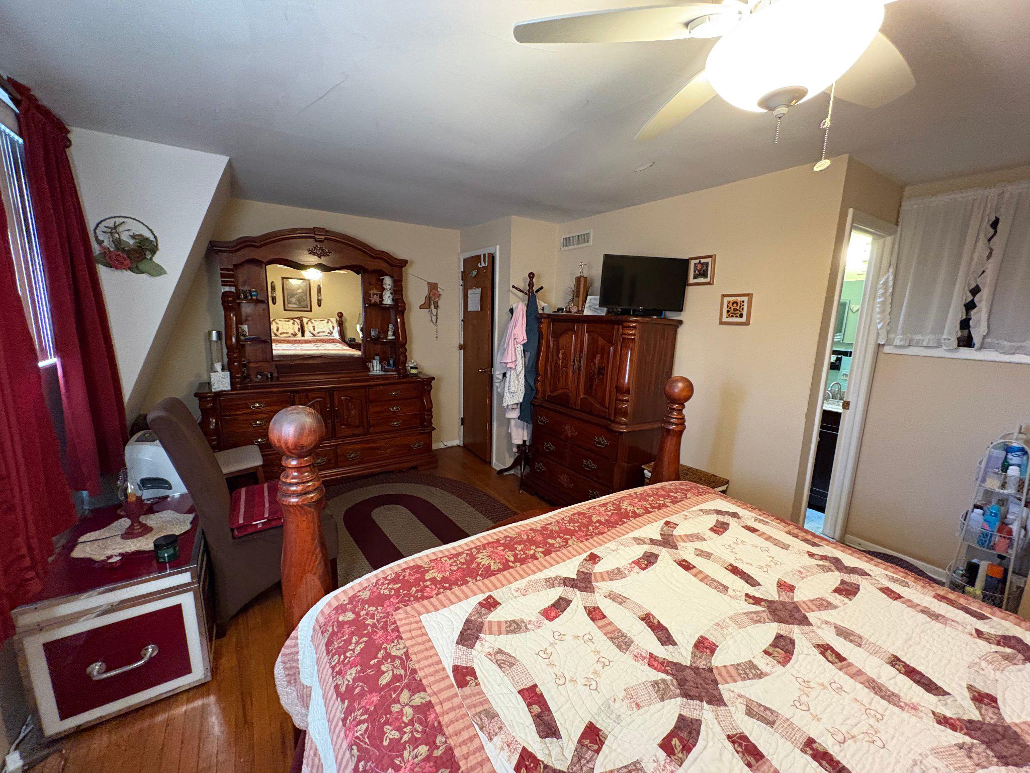 1045 Foster Street Philadelphia, PA 19116 - Photo 16 of 27 a bedroom with a bed and dresser with mirror