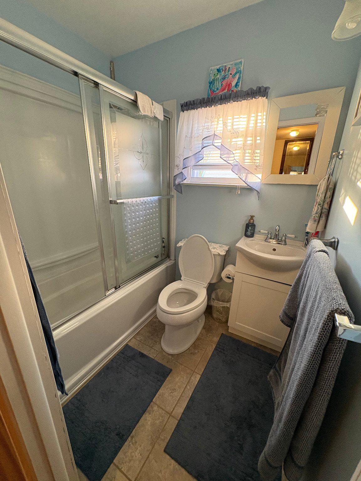 1045 Foster Street Philadelphia, PA 19116 - Photo 19 of 27 a bathroom with a granite countertop sink toilet a mirror and shower