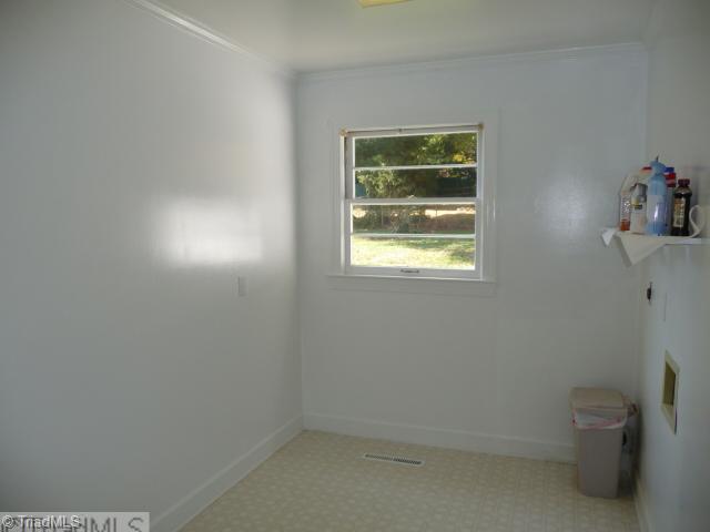 1236 Pinebluff Road Winston-Salem, NC 27103 - Photo 11 of 12 Laundry Room. Spacious laundry/mud room with utility shelf and new flooring
