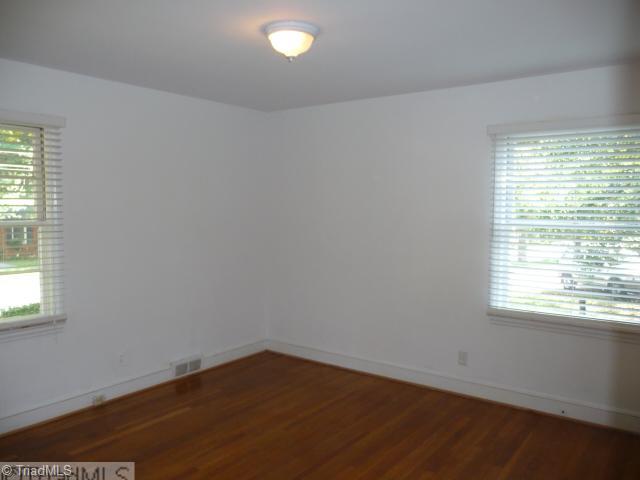 1236 Pinebluff Road Winston-Salem, NC 27103 - Photo 9 of 12 2nd Bedroom. Spacious neutral bedroom with HW flooring