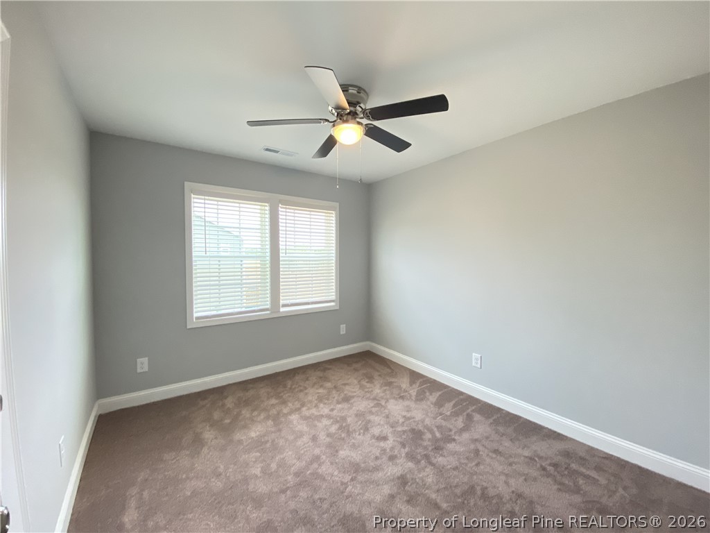 900 Allstar Avenue Cameron, NC 28326 - Photo 12 of 17 an empty room with windows and fan