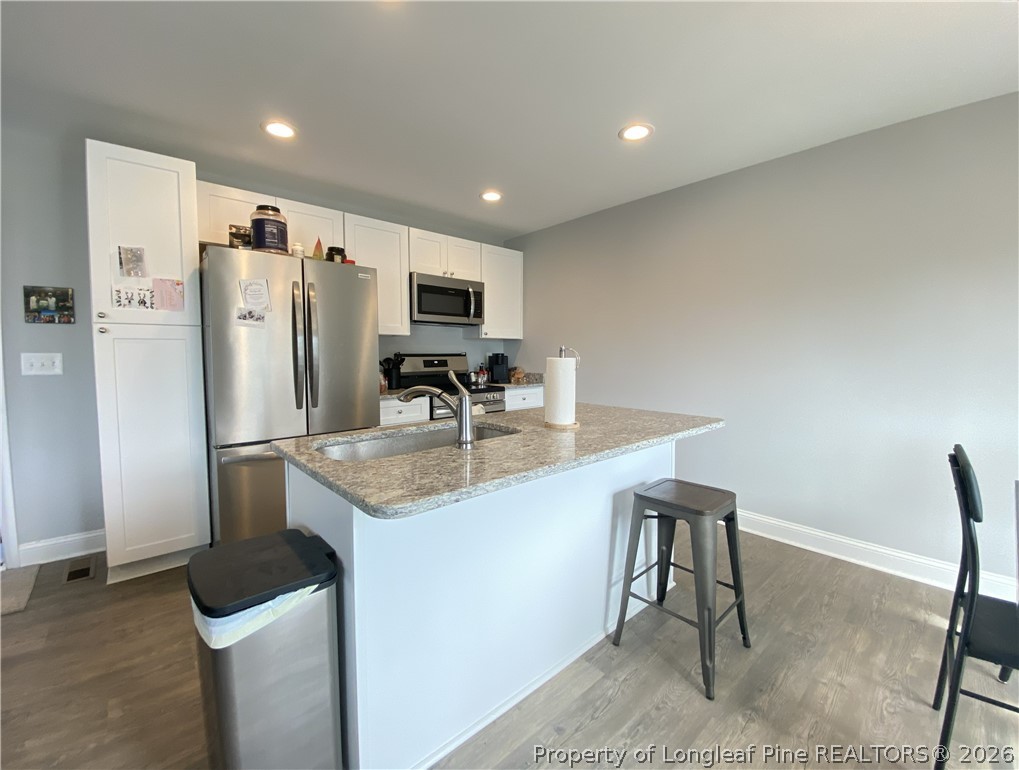 900 Allstar Avenue Cameron, NC 28326 - Photo 4 of 17 a kitchen with stainless steel appliances a refrigerator and a stove top oven