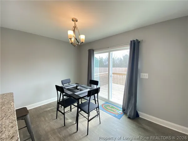 a bathroom with a granite countertop sink toilet and mirror