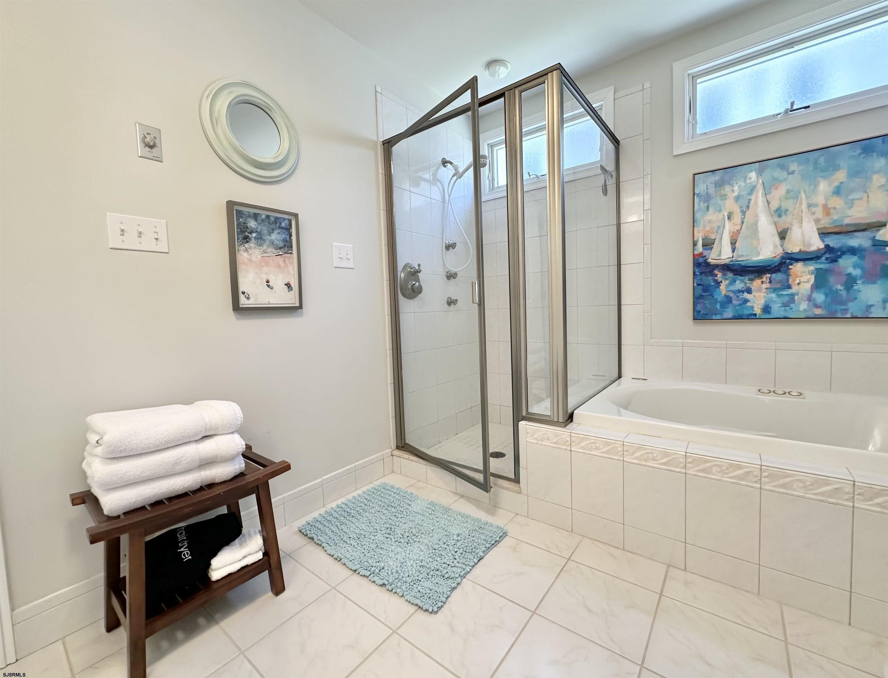 337 12th Street South Brigantine, NJ 08203 - Photo 13 of 36 a bathroom with a tub a sink and a mirror
