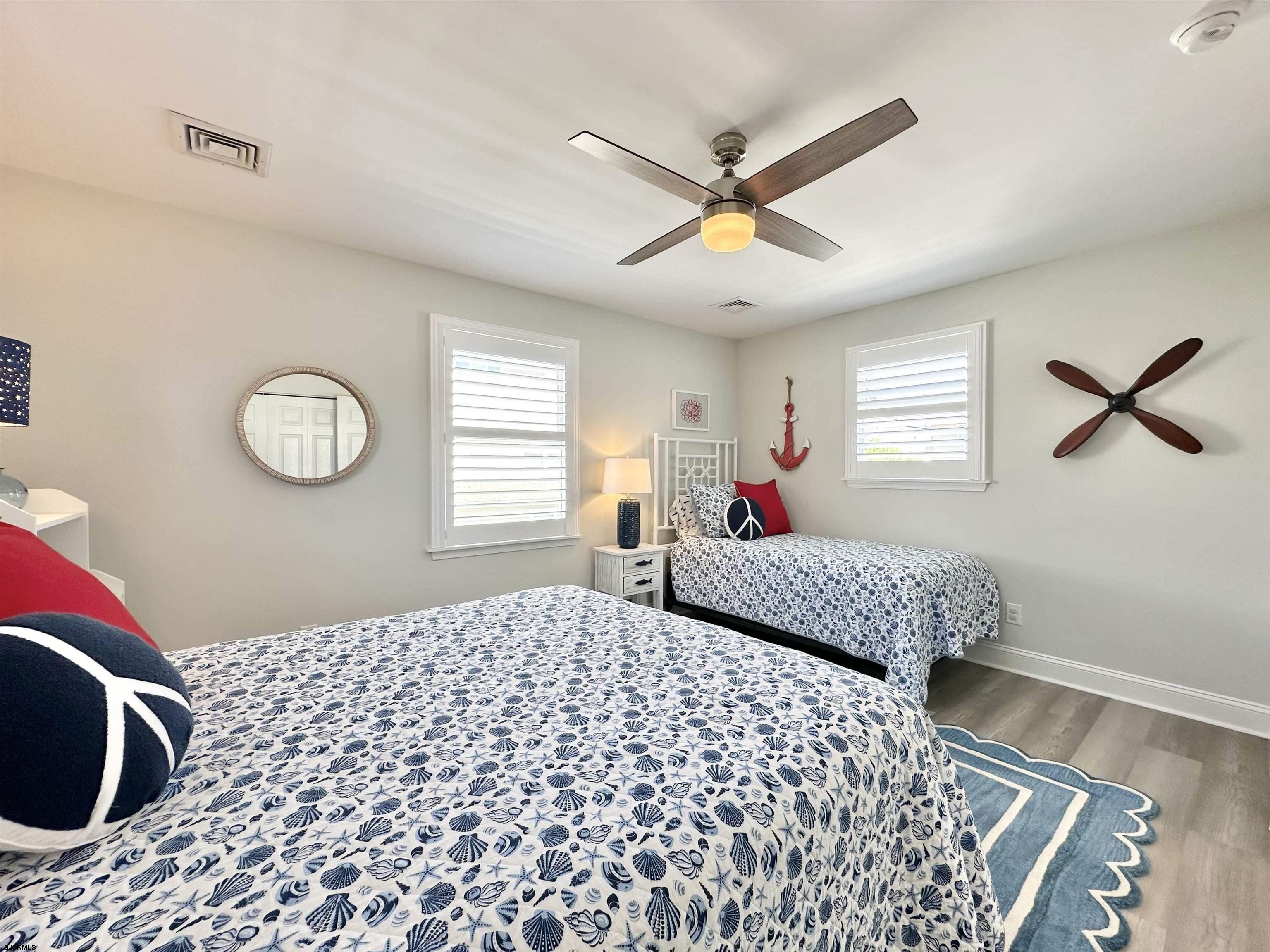 337 12th Street South Brigantine, NJ 08203 - Photo 26 of 36 a bedroom with a bed and a chandelier