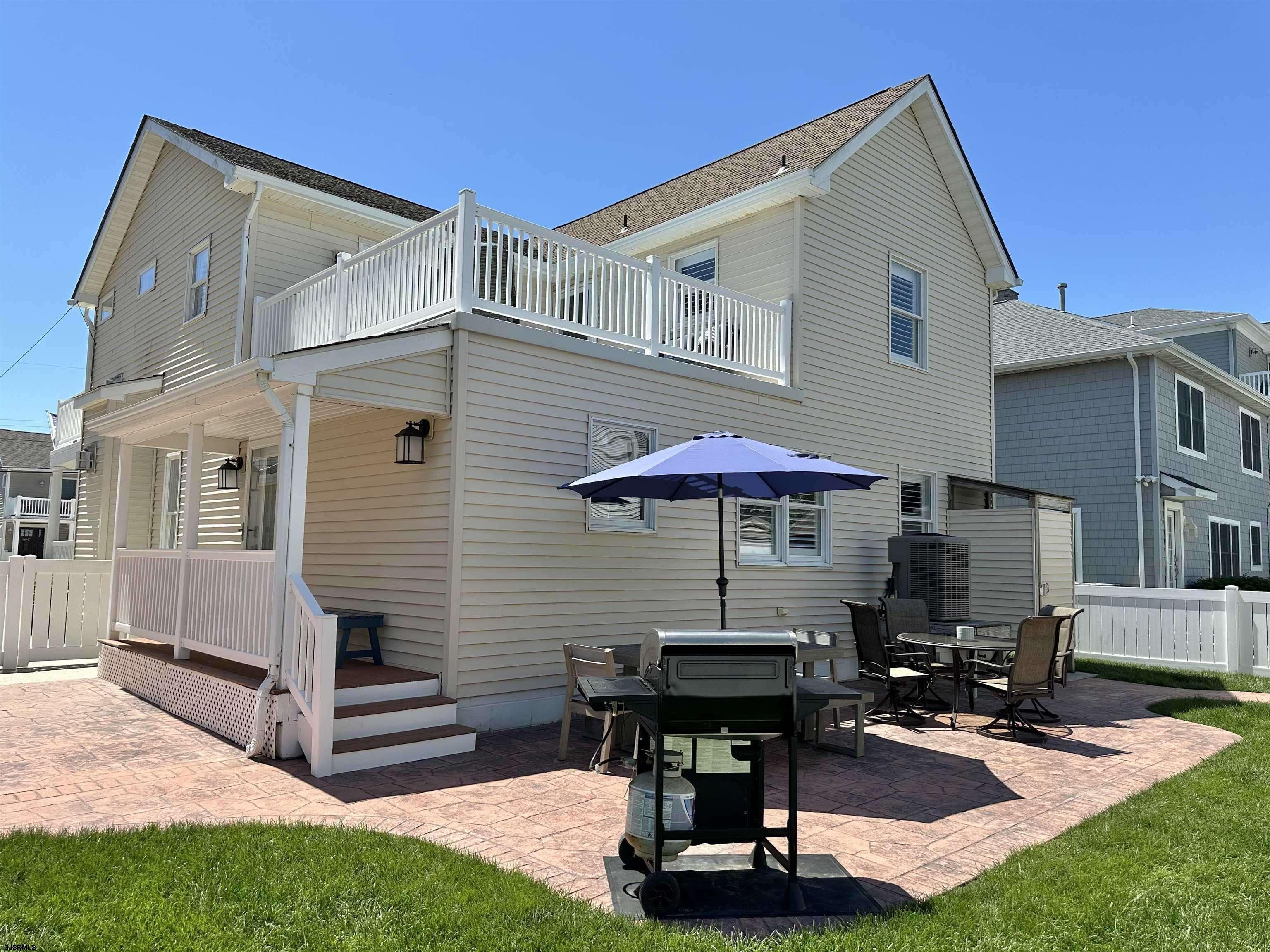 337 12th Street South Brigantine, NJ 08203 - Photo 30 of 36 a view of a patio with a table and chairs under an umbrella