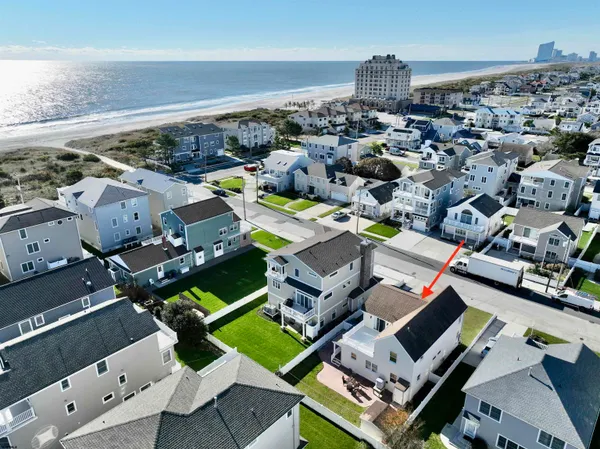 an aerial view of a house with a ocean view