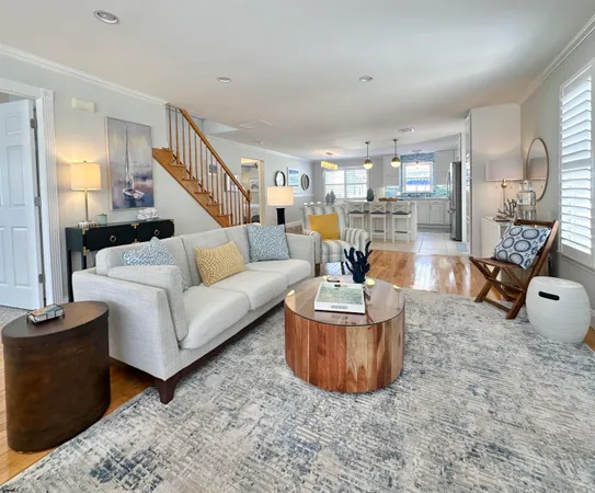 a living room with furniture a ceiling fan and a rug