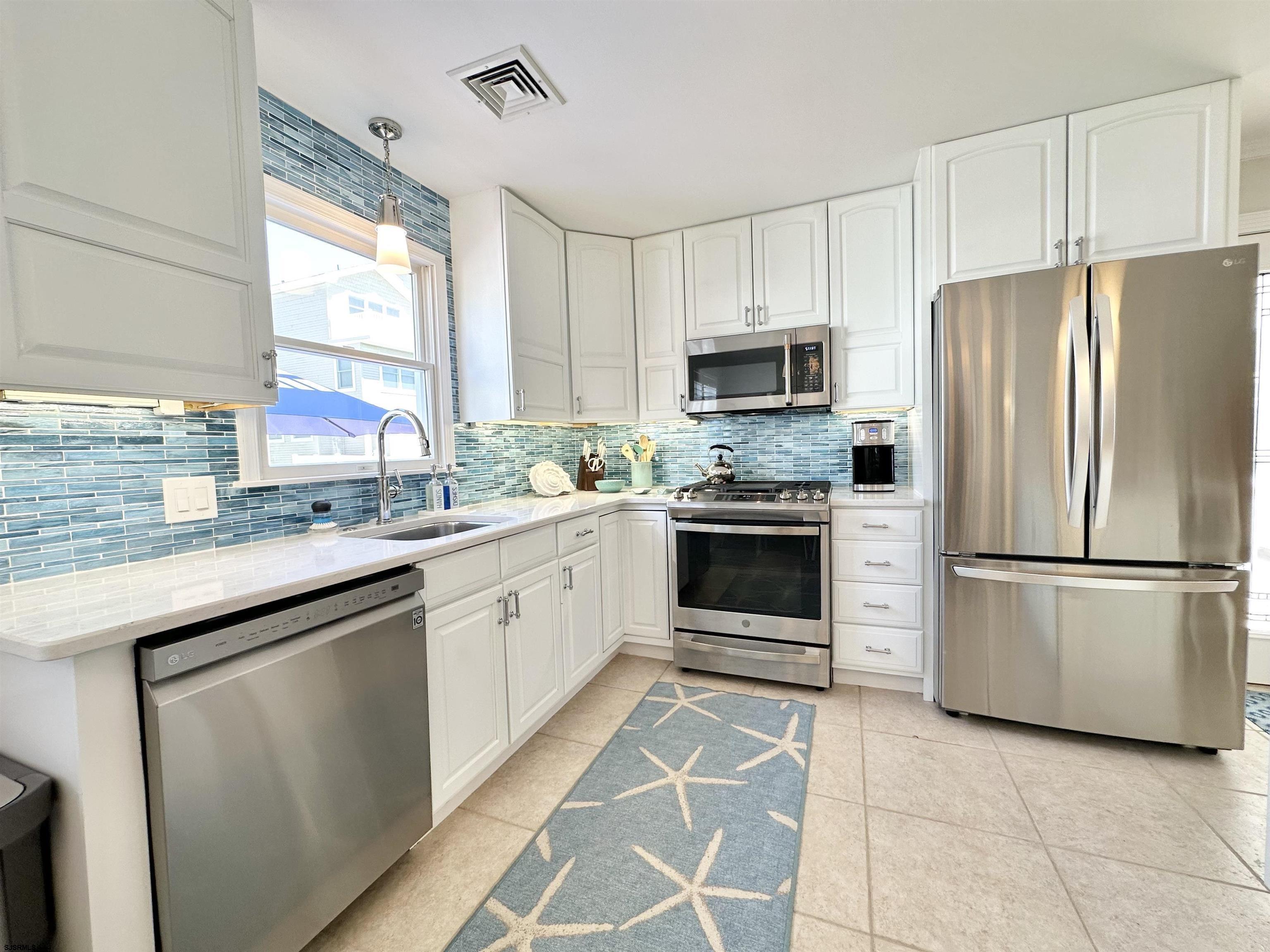 337 12th Street South Brigantine, NJ 08203 - Photo 6 of 36 a kitchen with cabinets stainless steel appliances and window