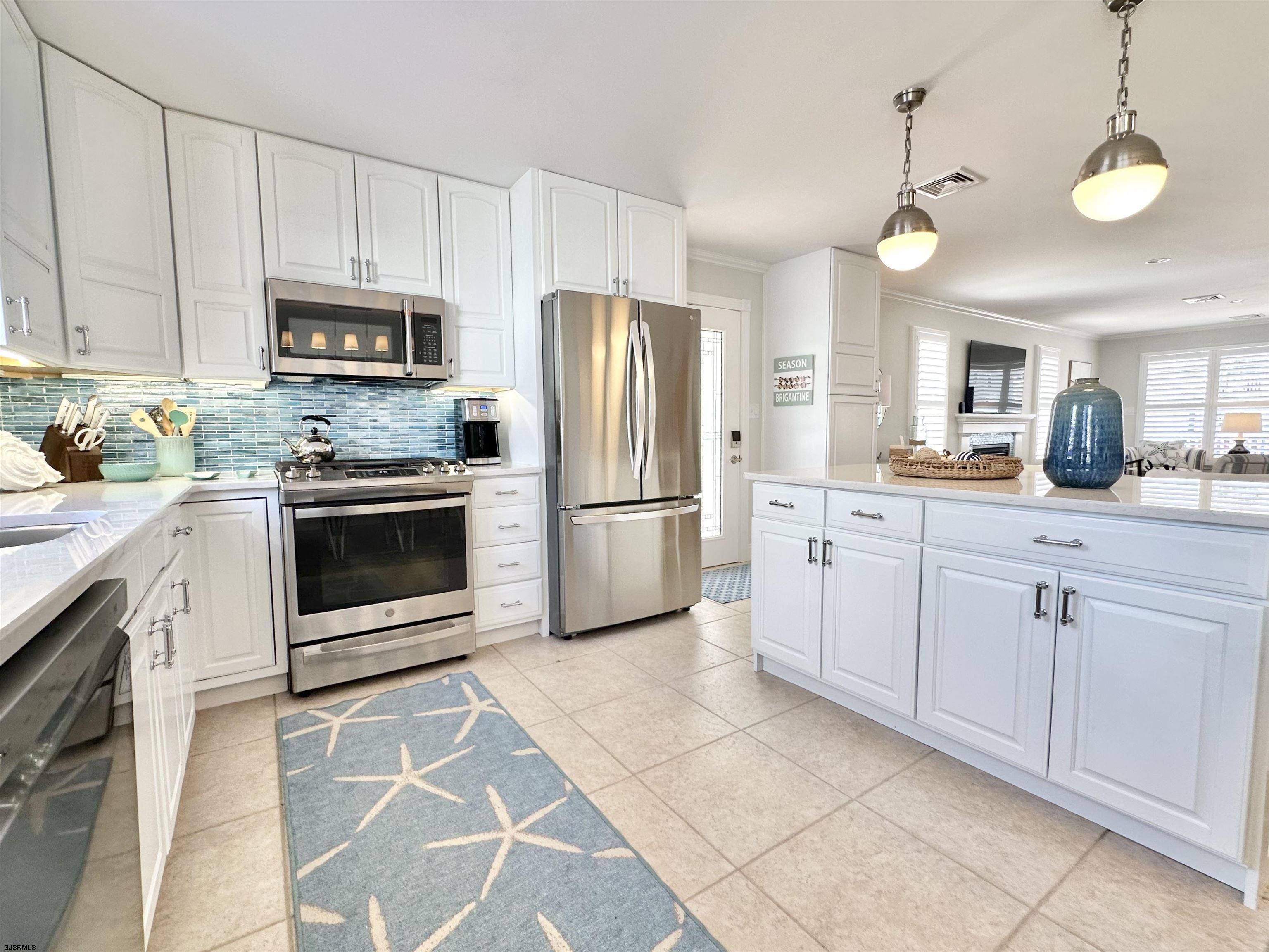 337 12th Street South Brigantine, NJ 08203 - Photo 7 of 36 a kitchen with stainless steel appliances granite countertop a stove a sink and a refrigerator