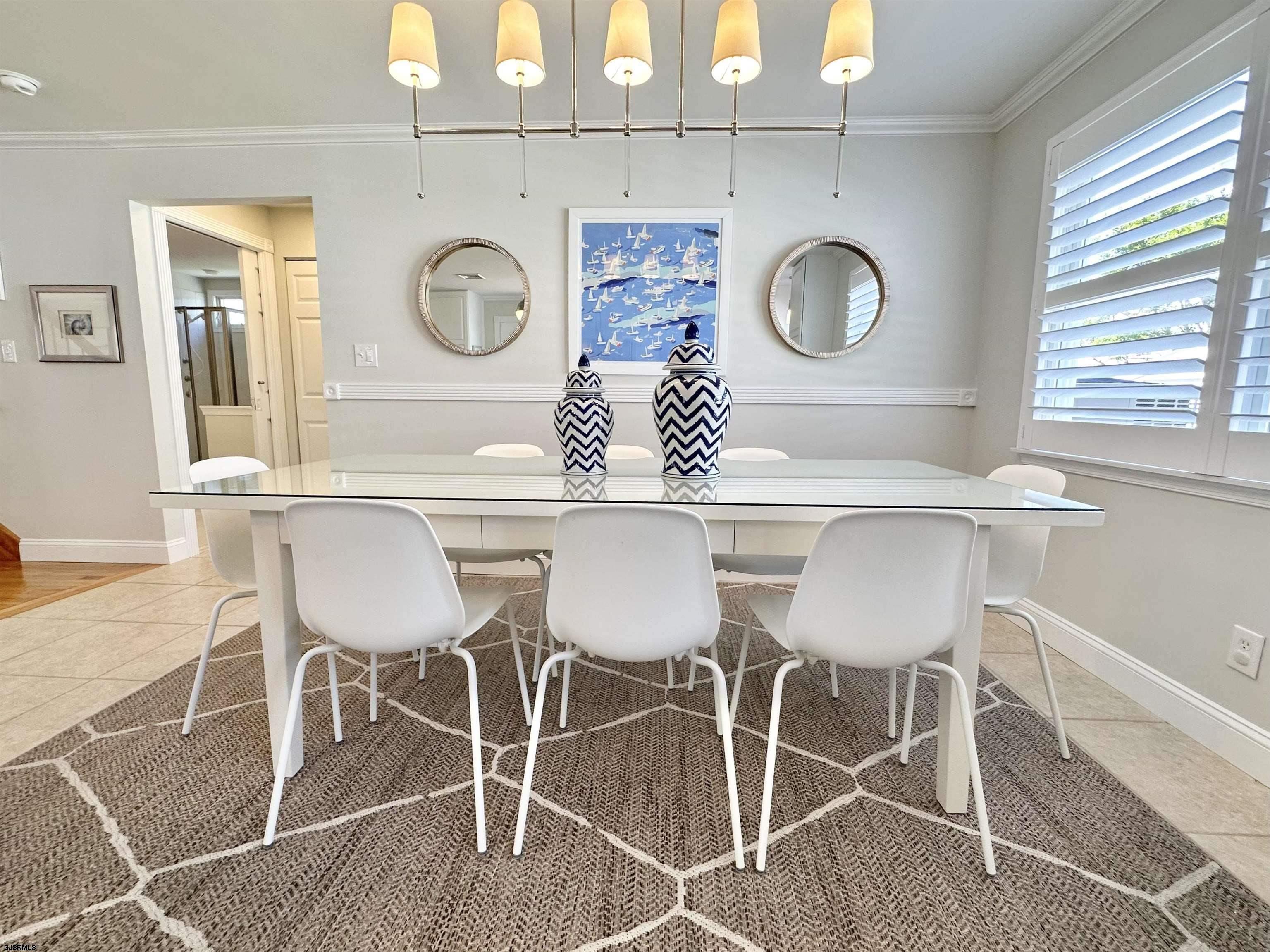 337 12th Street South Brigantine, NJ 08203 - Photo 8 of 36 a view of a dining room that has a table and a chair in it
