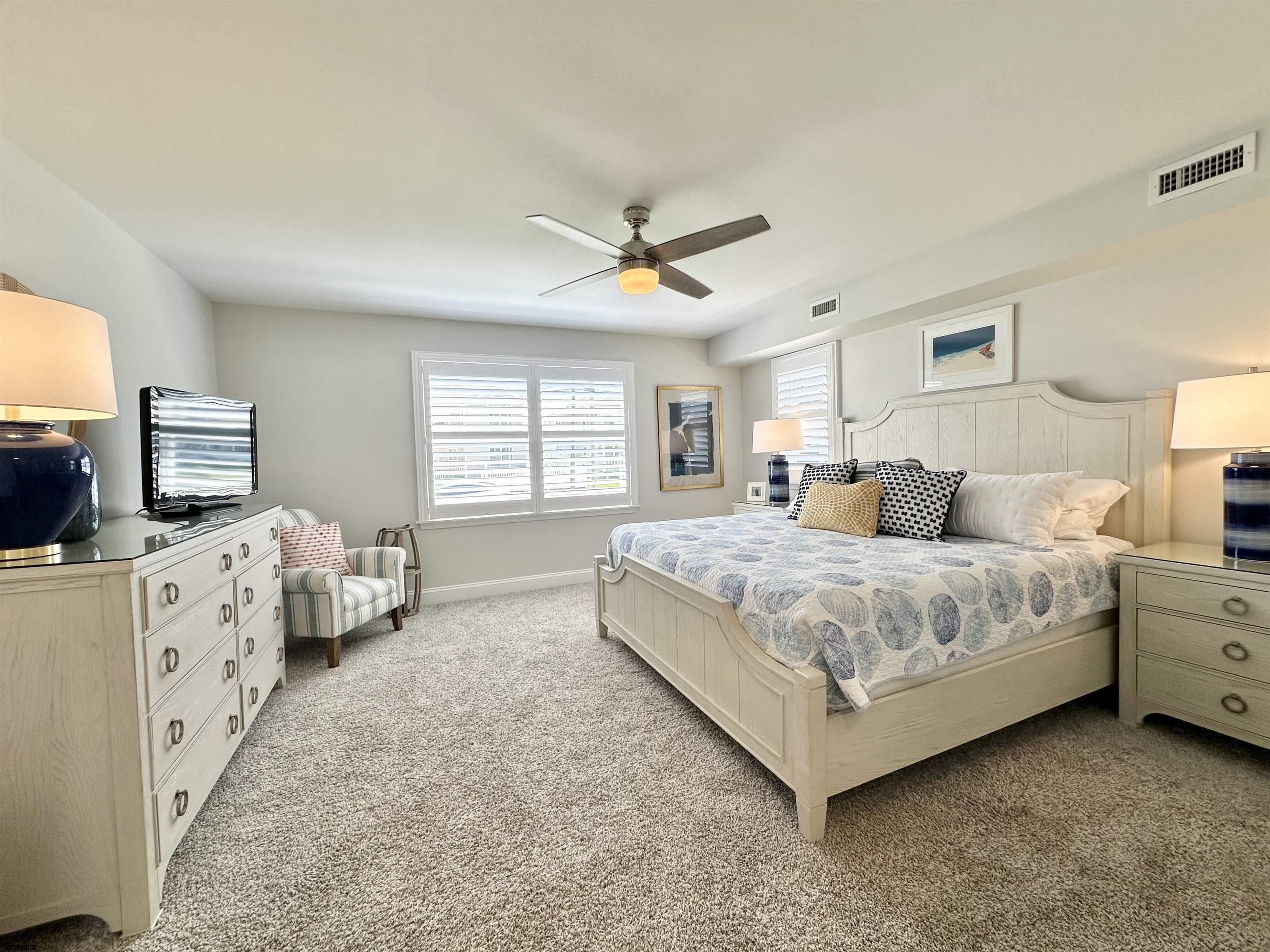 337 12th Street South Brigantine, NJ 08203 - Photo 9 of 36 a spacious bedroom with a bed and a flat screen tv