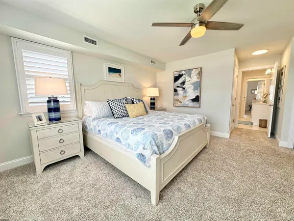 a bedroom with a large bed and a window
