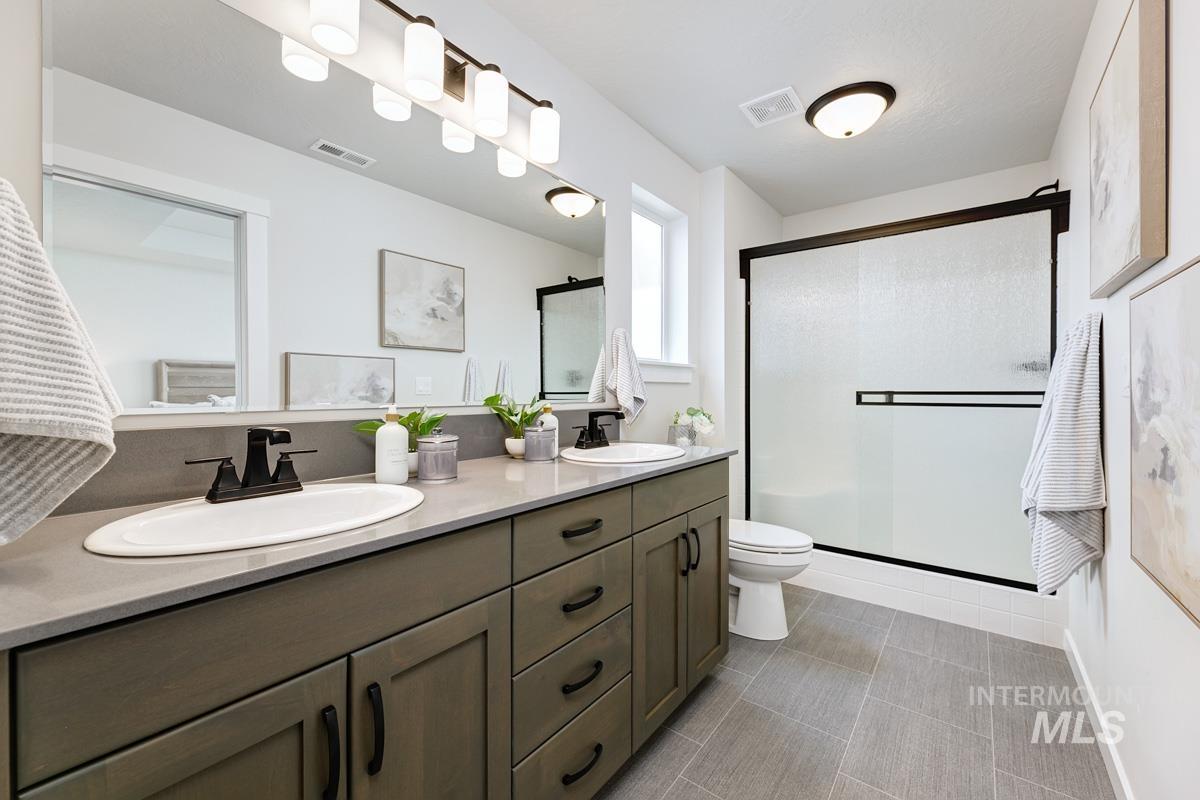 4309 South Zocalo Way Meridian, ID 83642 - Photo 12 of 26 Bathroom with double vanity and a shower stall
