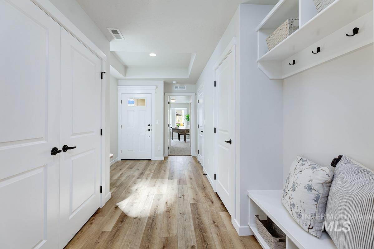 4309 South Zocalo Way Meridian, ID 83642 - Photo 14 of 26 Mudroom with light wood finished floors, a tray ceiling, and recessed lighting