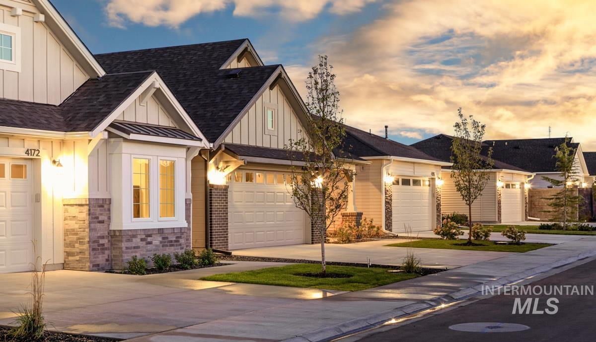 4309 South Zocalo Way Meridian, ID 83642 - Photo 16 of 26 Craftsman house with board and batten siding, roof with shingles, concrete driveway, and a standing seam roof