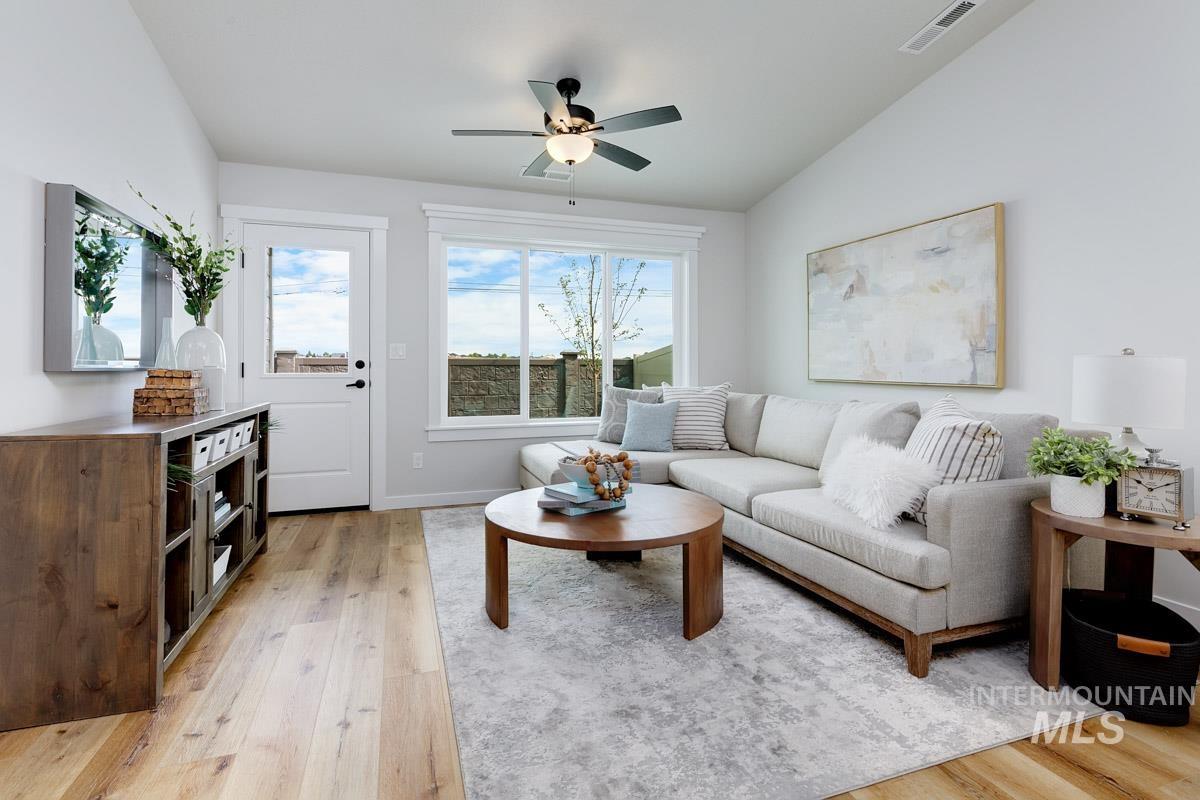 4309 South Zocalo Way Meridian, ID 83642 - Photo 8 of 26 Living room with lofted ceiling, light wood-type flooring, and ceiling fan