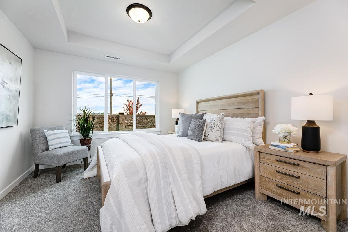 4309 South Zocalo Way Meridian, ID 83642 - Photo 10 of 26 Bedroom with a tray ceiling and dark carpet