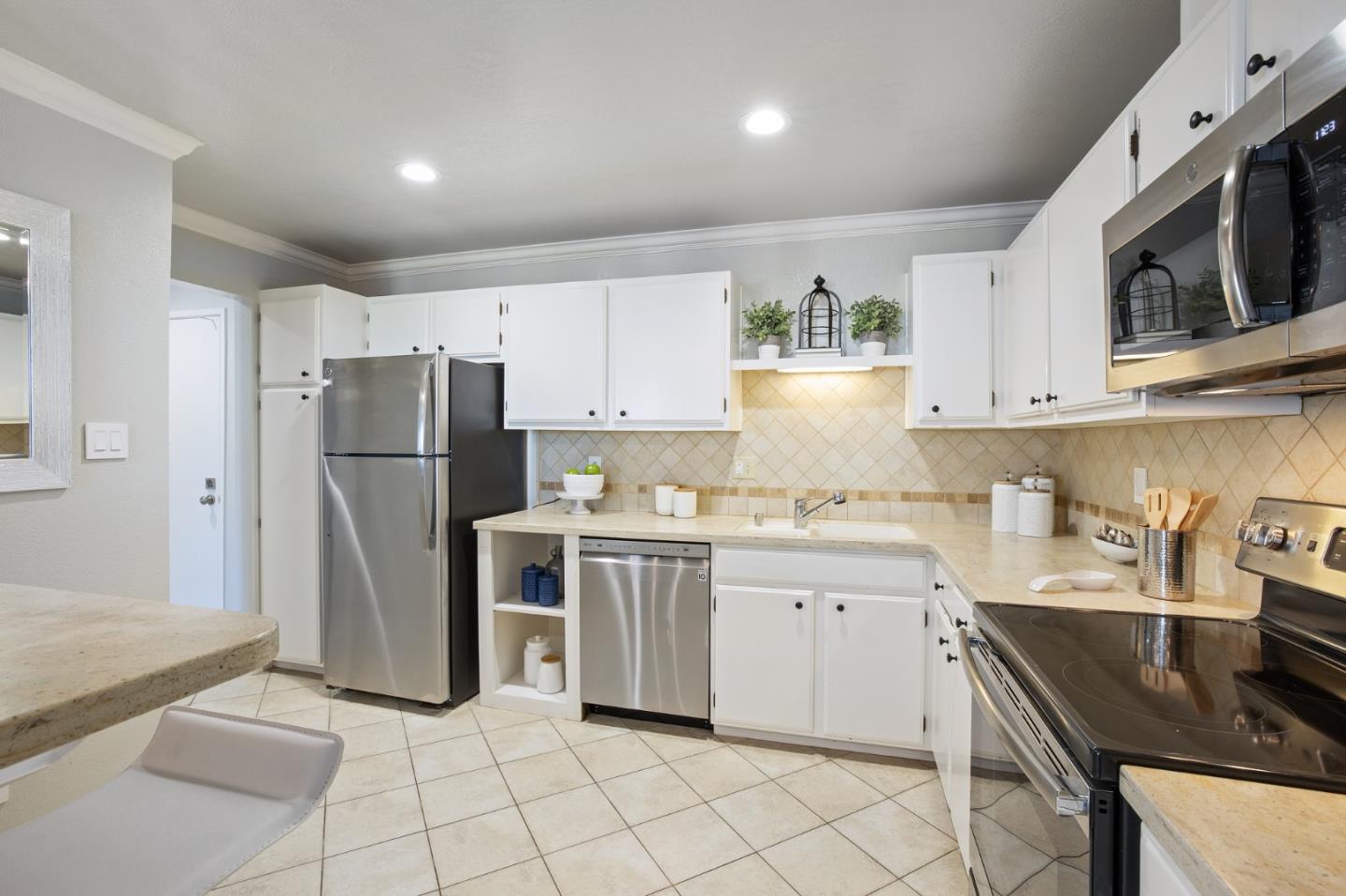 1171 Compass Lane, Unit 216 Foster City, CA 94404 - Photo 15 of 35 a kitchen with a refrigerator a microwave and cabinets