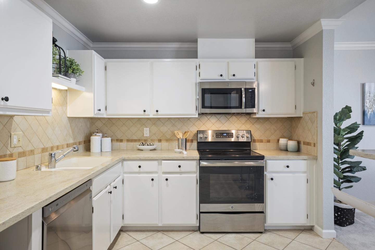 1171 Compass Lane, Unit 216 Foster City, CA 94404 - Photo 17 of 35 a kitchen with granite countertop white cabinets and white appliances