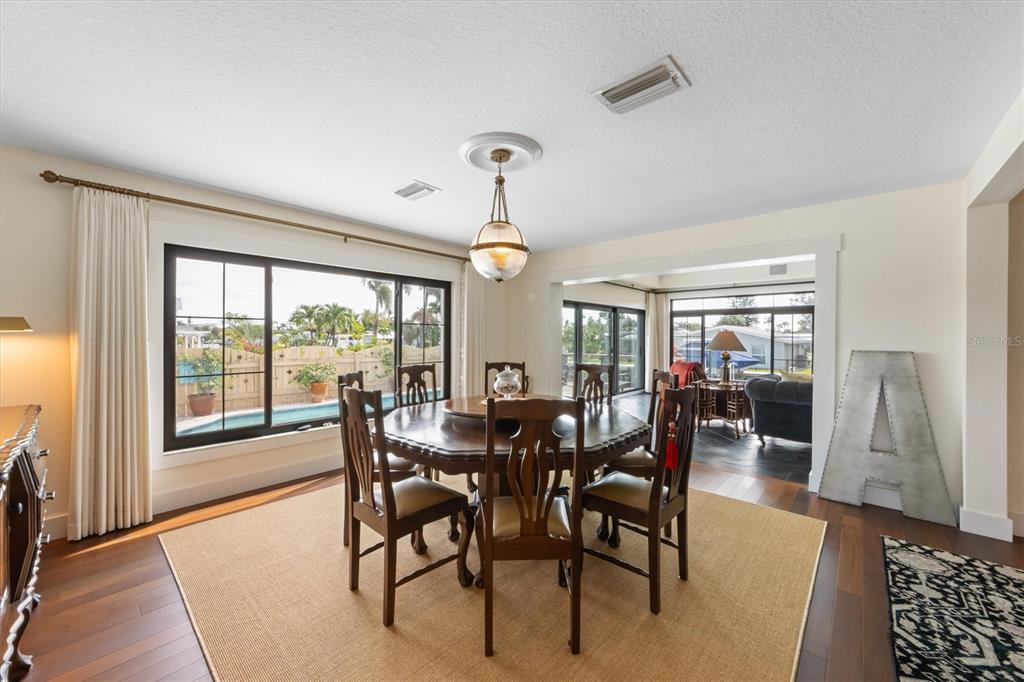 505 75th Street Holmes Beach, FL 34217 - Photo 13 of 75 a view of a dining room with furniture window and wooden floor