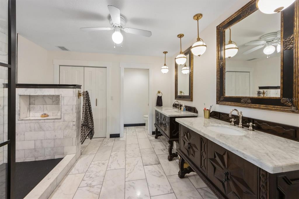 505 75th Street Holmes Beach, FL 34217 - Photo 38 of 75 a bathroom with a double vanity sink a mirror and a shower