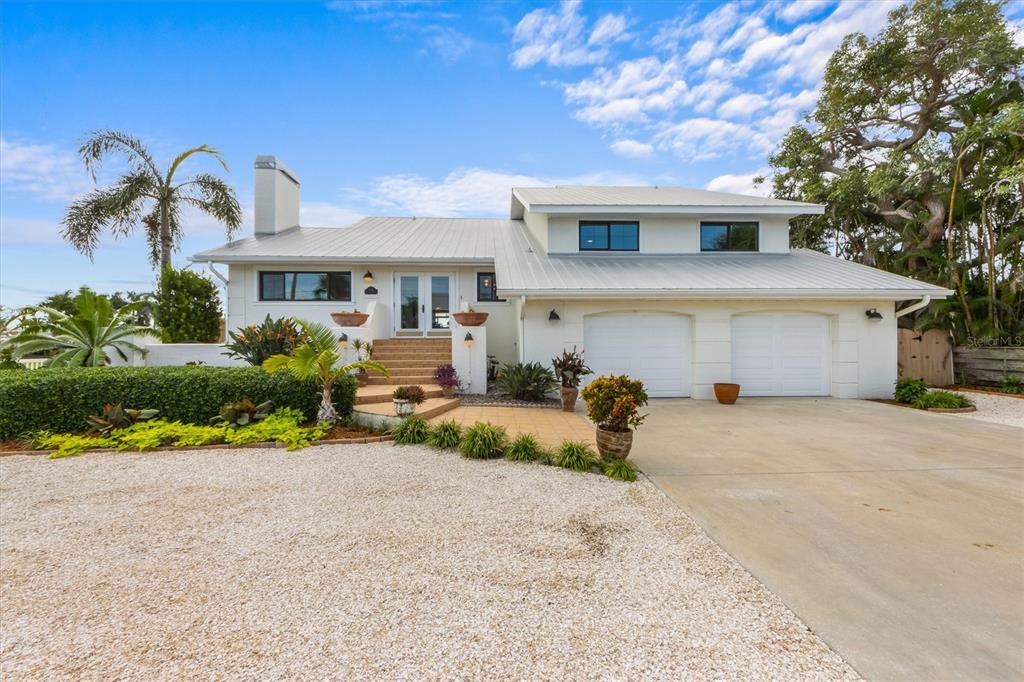 505 75th Street Holmes Beach, FL 34217 - Photo 5 of 75 a front view of a house with a yard and garage