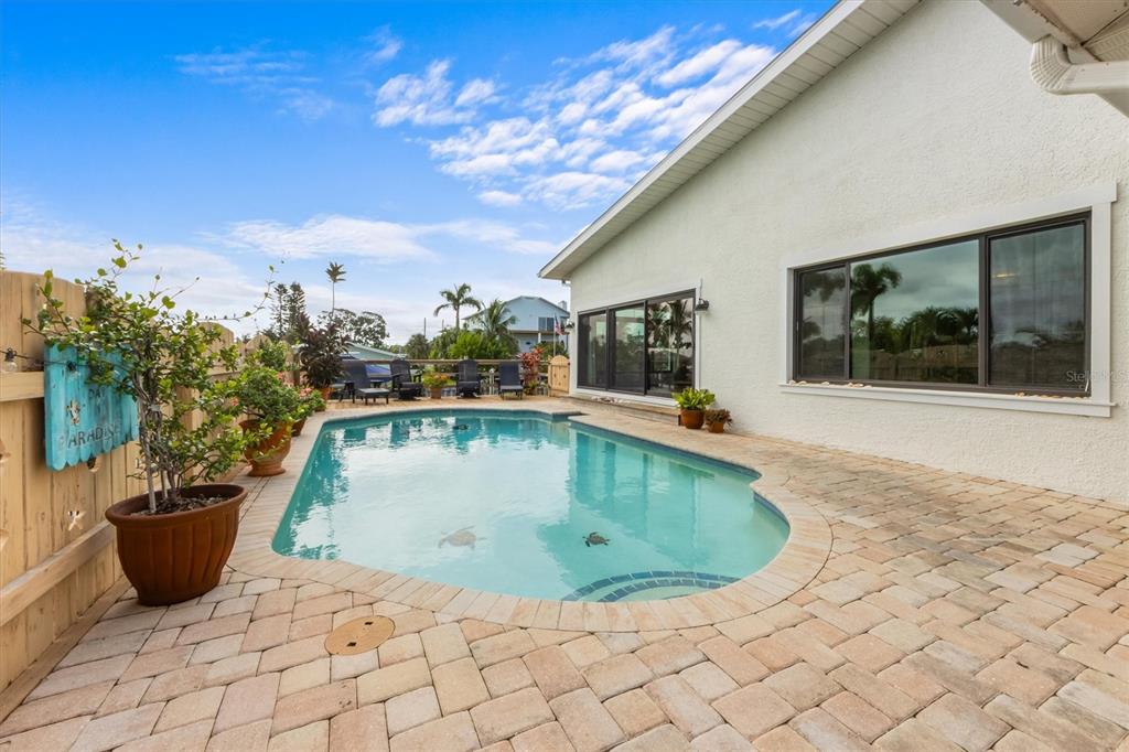 505 75th Street Holmes Beach, FL 34217 - Photo 62 of 75 a view of a swimming pool with an outdoor seating