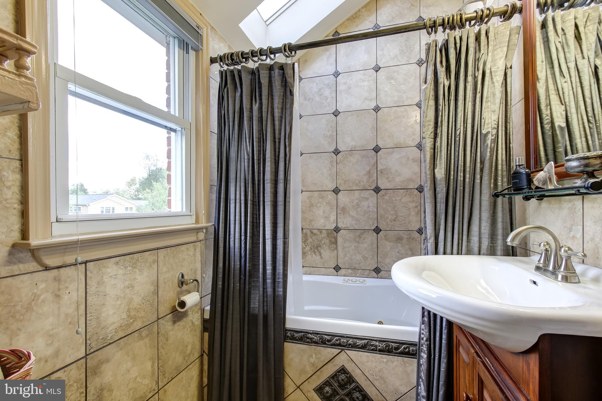 315 Penwood Road Silver Spring, MD 20901 - Photo 25 of 41 Upper level guest full bath with skylight