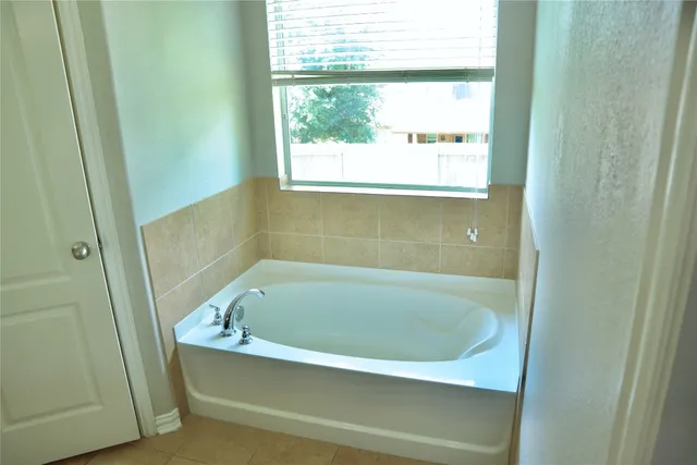 a white bath tub sitting in a bathroom