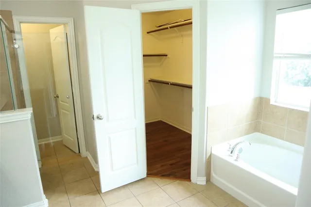 a bathroom with a tub and shower