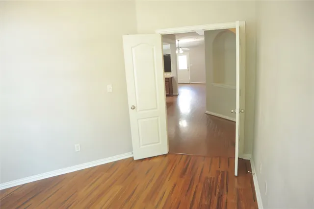 a view of hallway with wooden floor