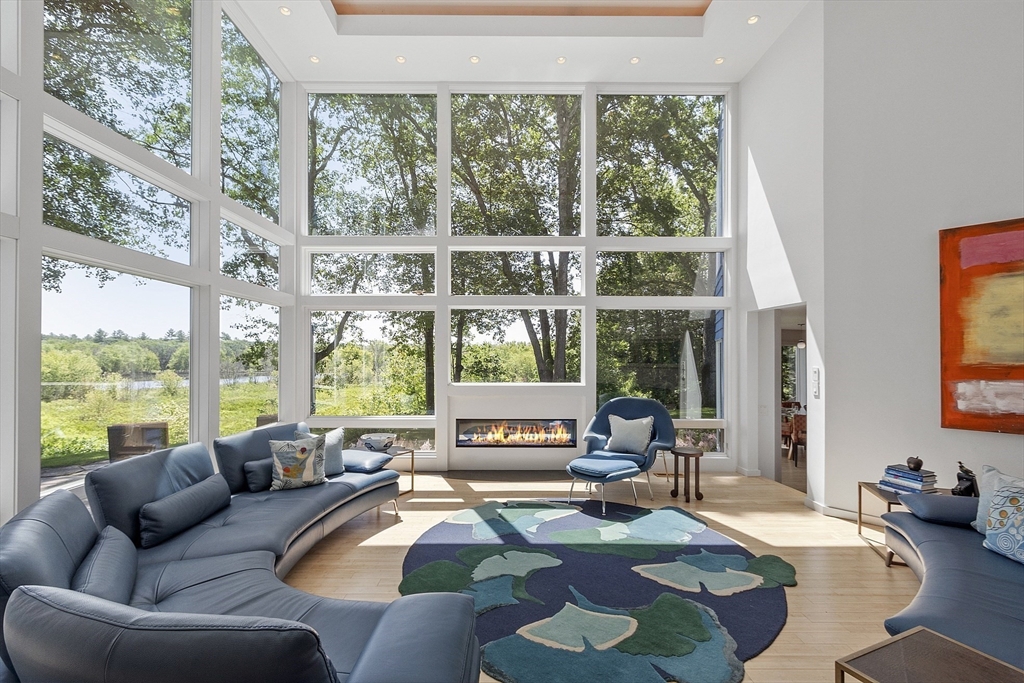 389 River Road Carlisle, MA 01741 - Photo 11 of 42 a living room with furniture and a large window