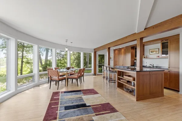 a living room with furniture a large window and a table